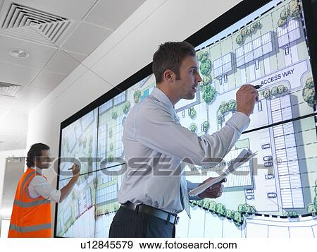 Town planners with plans on screen View Large Photo Image Stock Photo - Town planners with plans on screen. Fotosearch