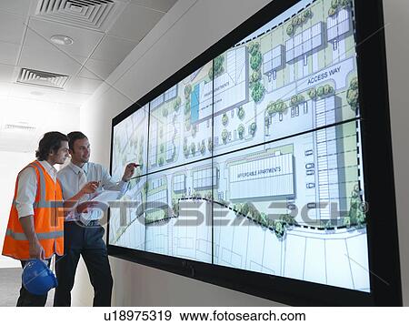 Stock Photo - Town planners work at plans on screen. Fotosearch