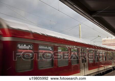Stock Image - Train leaving station. Fotosearch
