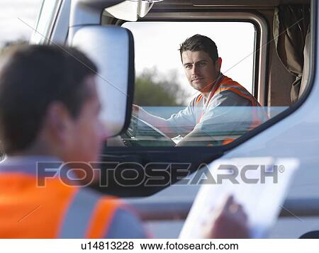 Truck driver with worker taking notes View Large Photo Image Stock Photo - Truck driver with worker taking notes. Fotosearch