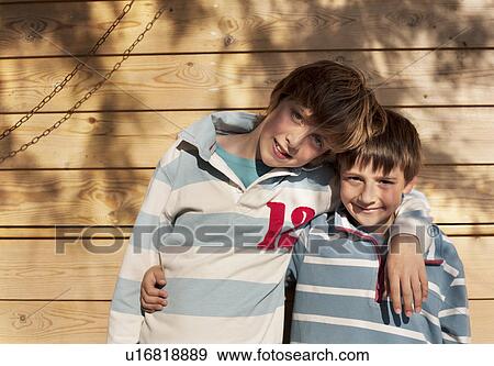 Two boys, arms round each other View Large Photo Image Stock Photo - Two boys, arms round each other. Fotosearch