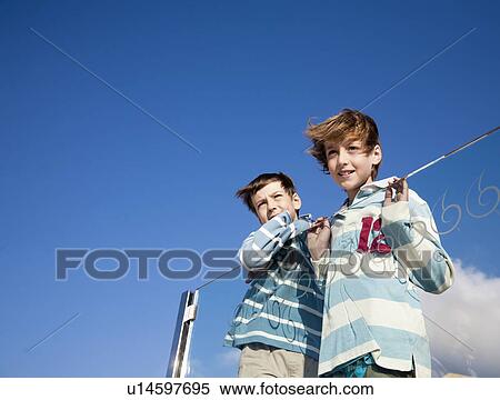 Stock Photography - Two boys looking at a view. Fotosearch