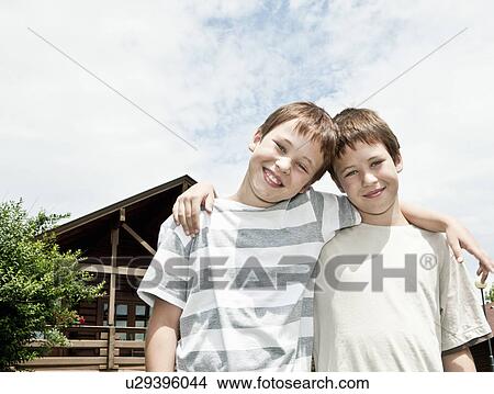 Two brothers hugging each other View Large Photo Image Picture - Two brothers hugging each other. Fotosearch