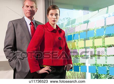 Two business people with wall of sticker View Large Photo Image Stock Image - Two business people with wall of sticker. Fotosearch