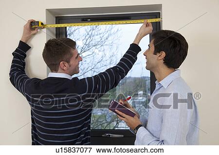 Two developers in their new apartment View Large Photo Image Stock Photo - Two developers in their new apartment. Fotosearch