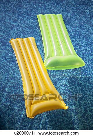 Two inflatable lilos in swimming pool View Large Photo Image Stock Image - Two inflatable lilos in swimming pool. Fotosearch