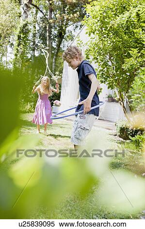 Stock Photography - Two kids doing sport in a garden. Fotosearch