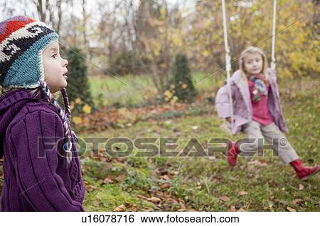 Stock Photograph - Two little girls playing in the garden. Fotosearch