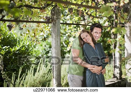 Two lovers hugging in nature View Large Photo Image Stock Photograph - Two lovers hugging in nature. Fotosearch