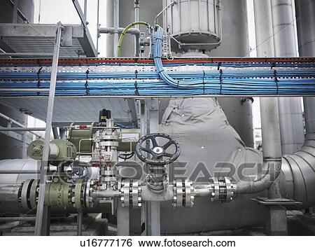 Stock Photograph - Valves and pipes at gas storage plant. Fotosearch