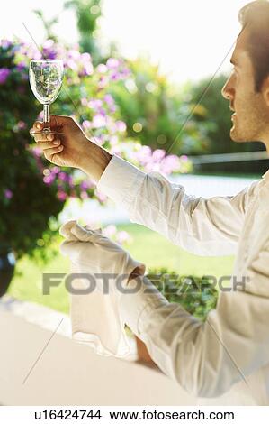Picture - Waiter cleaning wine glass. Fotosearch