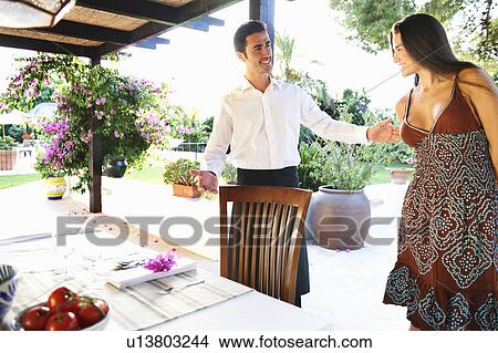 Waiter showing woman to dinner table View Large Photo Image Picture - Waiter showing woman to dinner table. Fotosearch