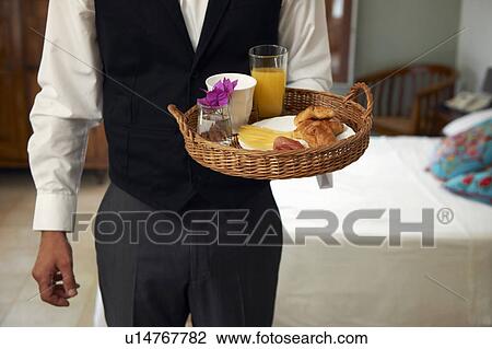 Stock Image - Waiter with breakfast tray. Fotosearch