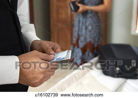 Stock Photo - Waiter with tip from woman. Fotosearch
