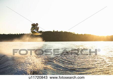 Wakeboarder at sunset View Large Photo Image Stock Image - Wakeboarder at sunset. Fotosearch