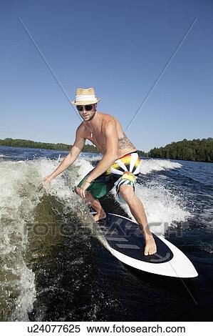 Stock Photography - Wakesurfer riding wave. Fotosearch