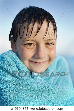 Stock Photo - Wet boy, wrapped in towel. Fotosearch