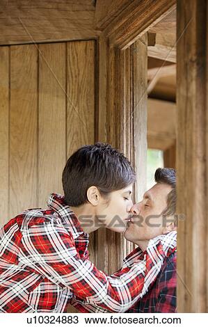 Woman and man kissing in park hut View Large Photo Image Stock Image - Woman and man kissing in park hut. Fotosearch