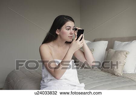 Woman applying mascara View Large Photo Image Stock Image - Woman applying mascara. Fotosearch