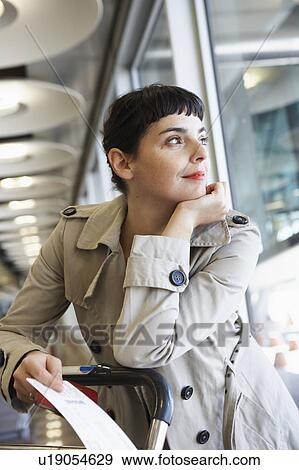 Stock Photo - Woman at airport waiting. Fotosearch