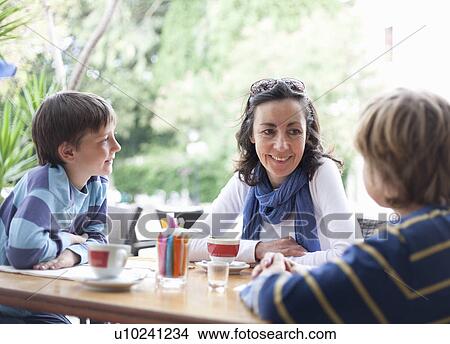 Woman at cafe with two boys View Large Photo Image Picture - Woman at cafe with two boys. Fotosearch