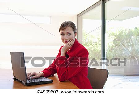 Stock Photo - Woman at computer in light office. Fotosearch