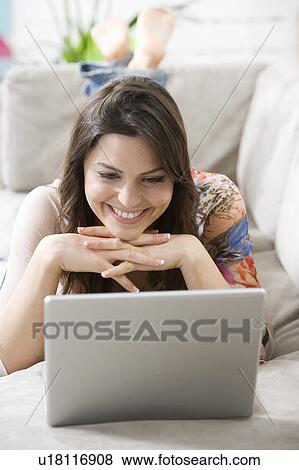 Stock Photo - Woman at home on the computer. Fotosearch