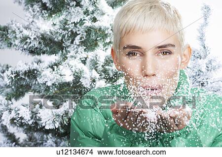 Woman blowing snow through the camera View Large Photo Image Picture - Woman blowing snow through the camera. Fotosearch