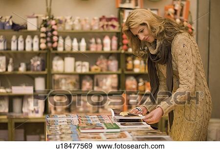 Woman browsing in books View Large Photo Image Stock Photo - Woman browsing in books. Fotosearch