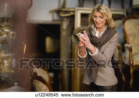 Stock Photography - Woman browsing in shop. Fotosearch
