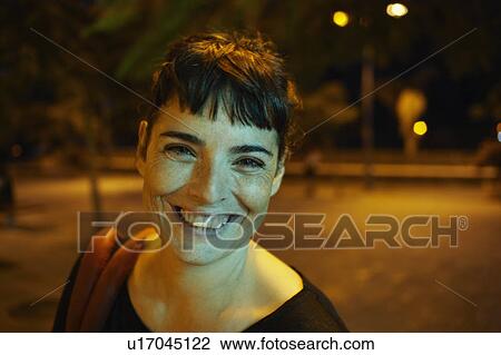 Woman by night smiling to camera View Large Photo Image Stock Image - Woman by night smiling to camera. Fotosearch