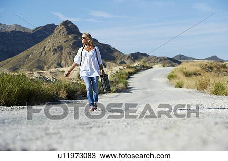 Woman carrying petrol can on the road View Large Photo Image Stock Image - Woman carrying petrol can on the road. Fotosearch