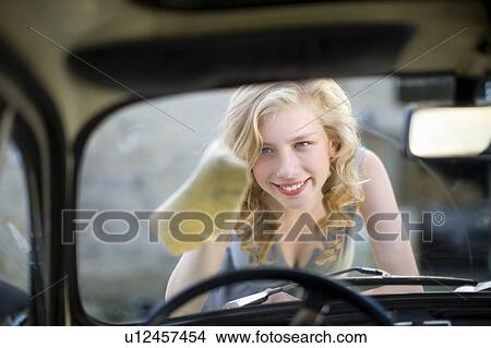 Picture - Woman cleaning her car. Fotosearch