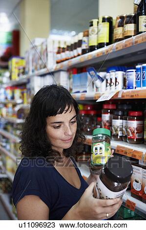 Woman comparing products View Large Photo Image Stock Image - Woman comparing products. Fotosearch