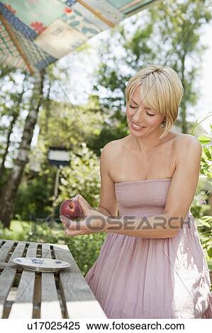 Woman cutting a peach View Large Photo Image Stock Photography - Woman cutting a peach. Fotosearch