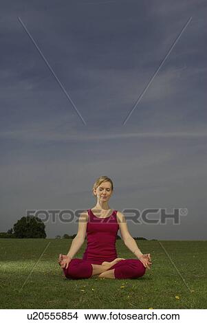 Woman doing yoga in park View Large Photo Image Picture - Woman doing yoga in park. Fotosearch