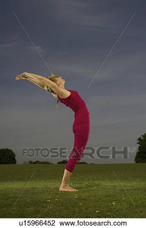 Woman doing yoga in park View Large Photo Image Stock Image - Woman doing yoga in park. Fotosearch