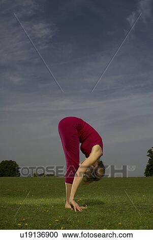 Woman doing yoga in park View Large Photo Image Stock Image - Woman doing yoga in park. Fotosearch
