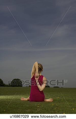 Woman doing yoga in park View Large Photo Image Stock Photo - Woman doing yoga in park. Fotosearch