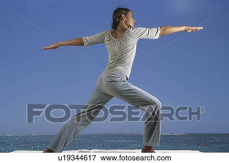 Woman doing yoga on beach View Large Photo Image Stock Photo - Woman doing yoga on beach. Fotosearch