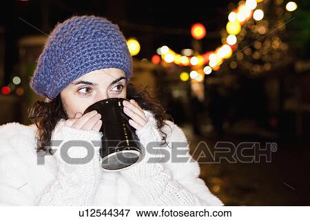 Stock Photo - Woman drinking hot drink. Fotosearch