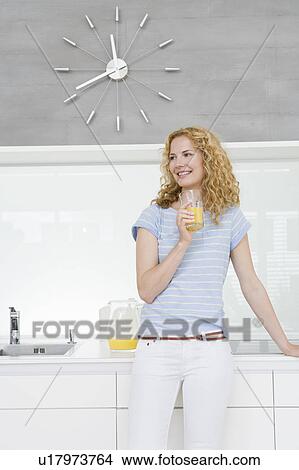 Woman drinking orange juice View Large Photo Image Picture - Woman drinking orange juice. Fotosearch