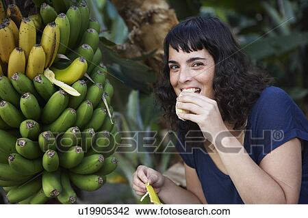Woman eating fresh banana View Large Photo Image Stock Image - Woman eating fresh banana. Fotosearch