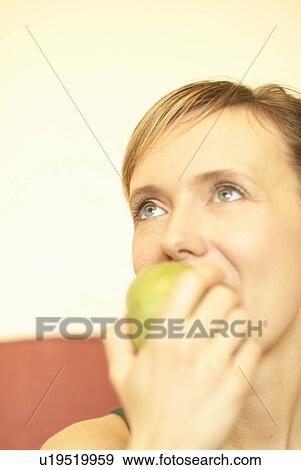Woman eating green apple View Large Photo Image Stock Photo - Woman eating green apple. Fotosearch