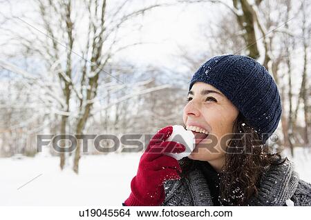 Woman eating snowball View Large Photo Image Picture - Woman eating snowball. Fotosearch
