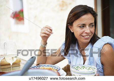 Woman having lunch View Large Photo Image Stock Photo - Woman having lunch. Fotosearch