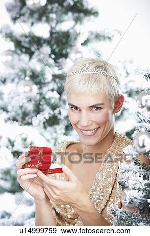 Woman holding a christmas gift View Large Photo Image Stock Photo - Woman holding a christmas gift. Fotosearch