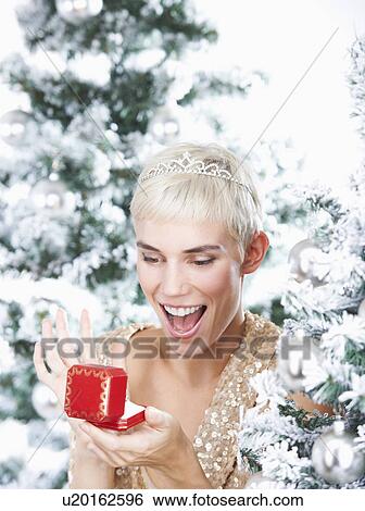 Woman holding a christmas gift View Large Photo Image Stock Photograph - Woman holding a christmas gift. Fotosearch