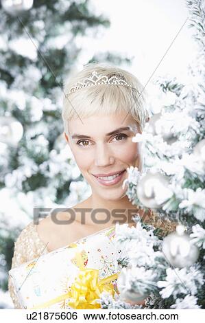 Woman holding a christmas gift View Large Photo Image Stock Photograph - Woman holding a christmas gift. Fotosearch