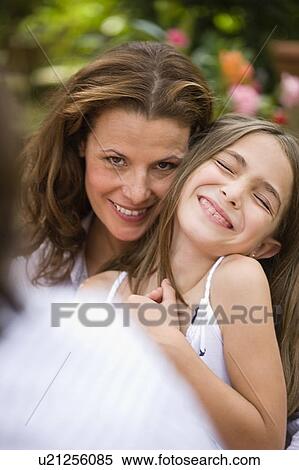 Stock Photography - Woman holding a laughing girl. Fotosearch